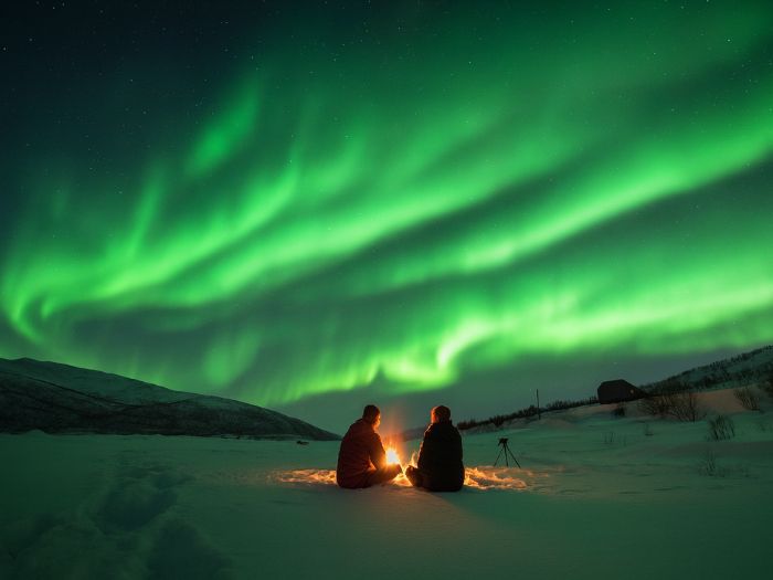 Our client near fire watching northern lights at Tromso