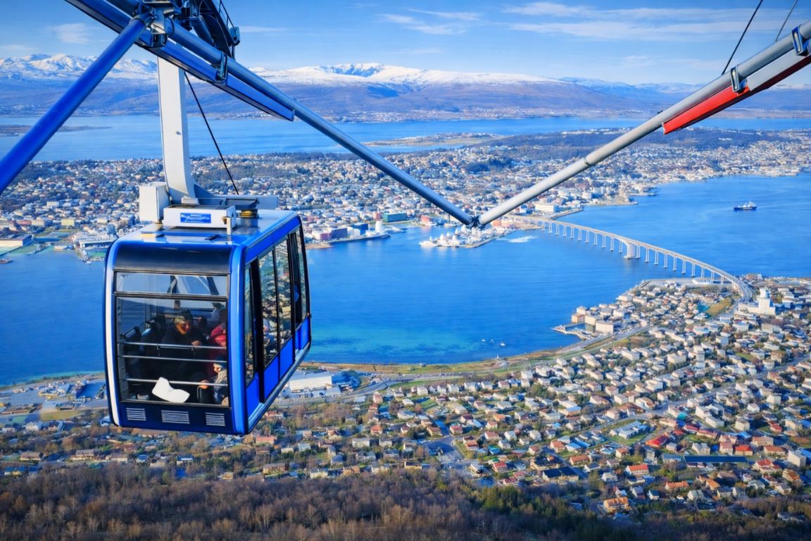 Tromsø Fjellheisen cable car captured on a Tromso Norway Tours guided city tour, featuring the gondola rising above the city, harbor, and surrounding Arctic landscape