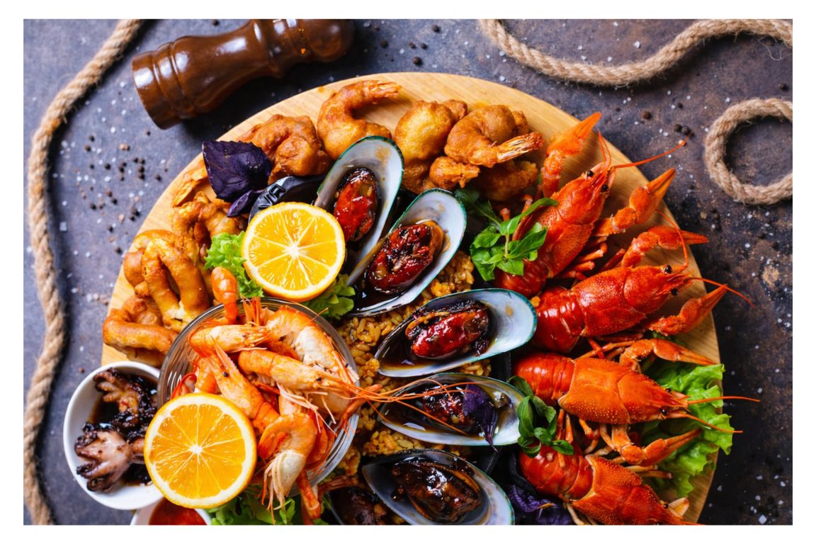 Fresh Norwegian seafood board with prawns, mussels and crayfish served on a Tromso Norway Tours fjord and food experience